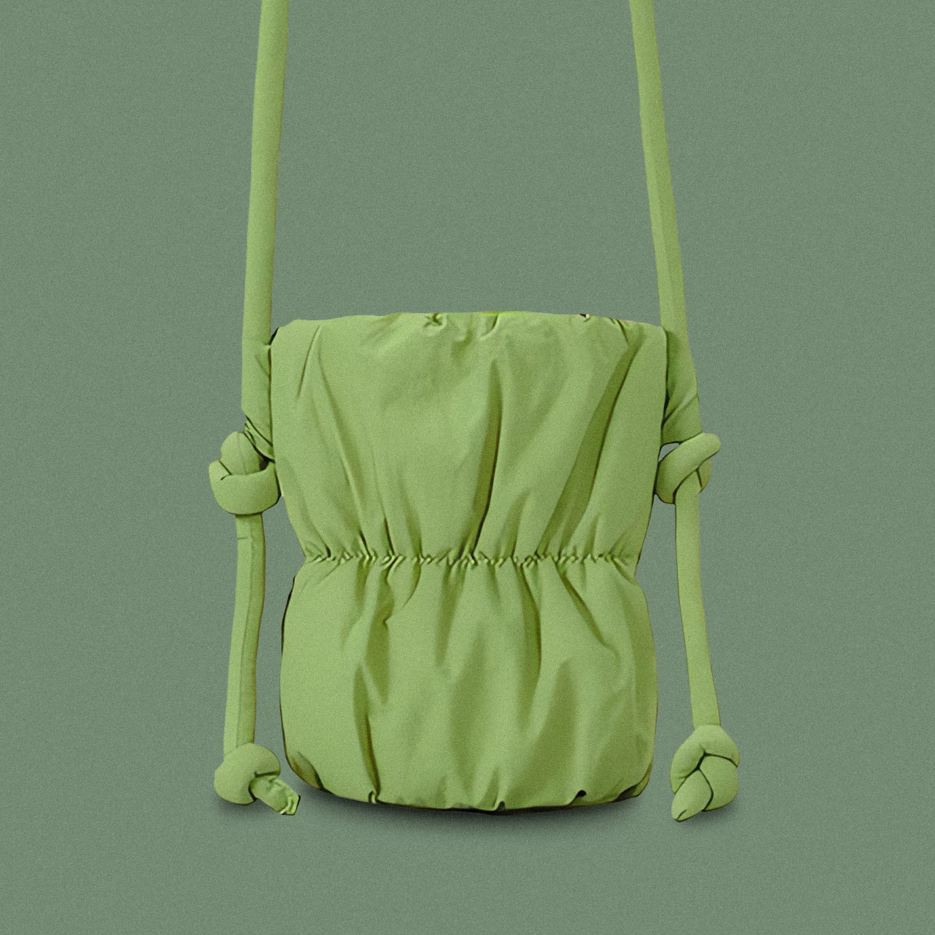 PLSH forest green women’s designer puffer handbag on a green background