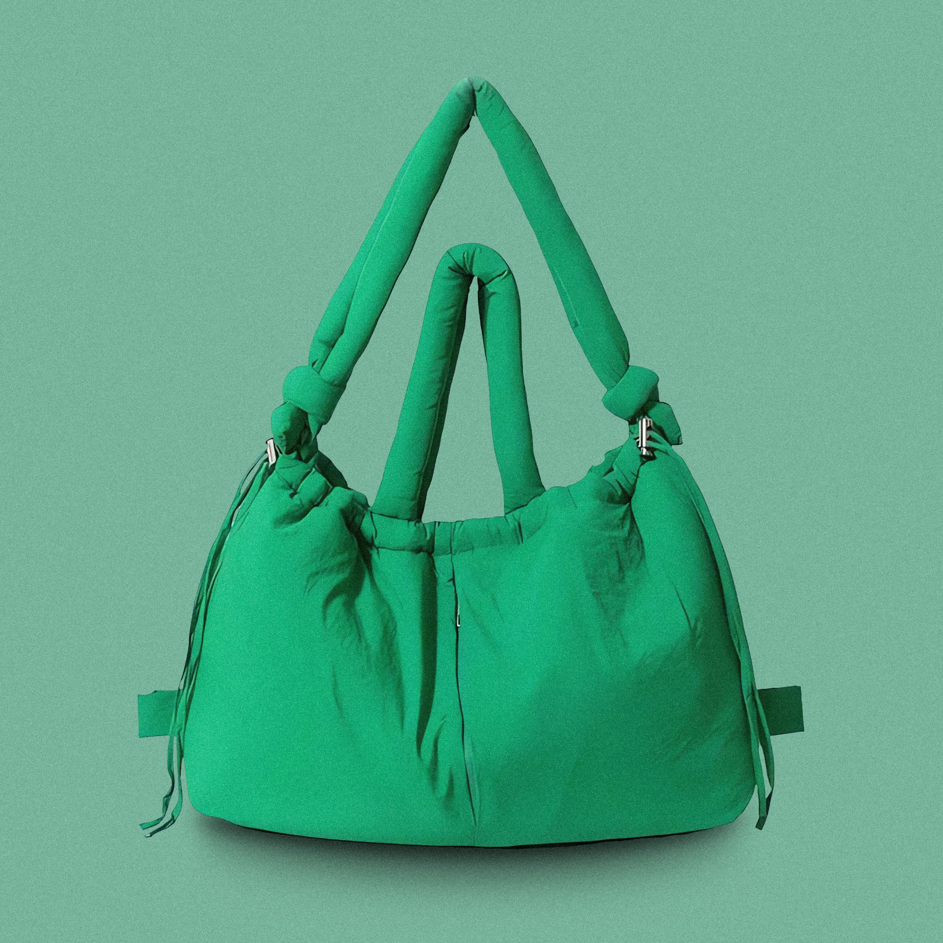 PLSH green women’s designer puffer handbag on a green background