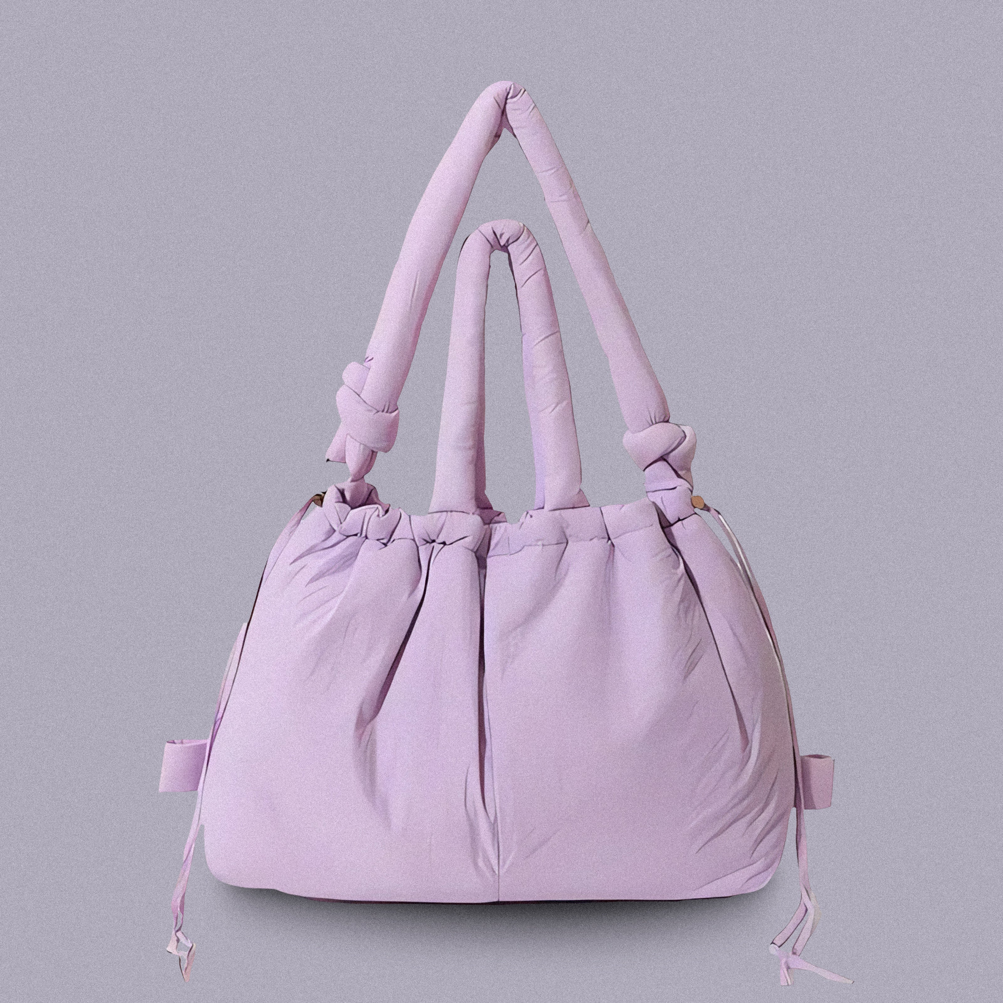 PLSH lilac women’s designer puffer handbag on a lilac background