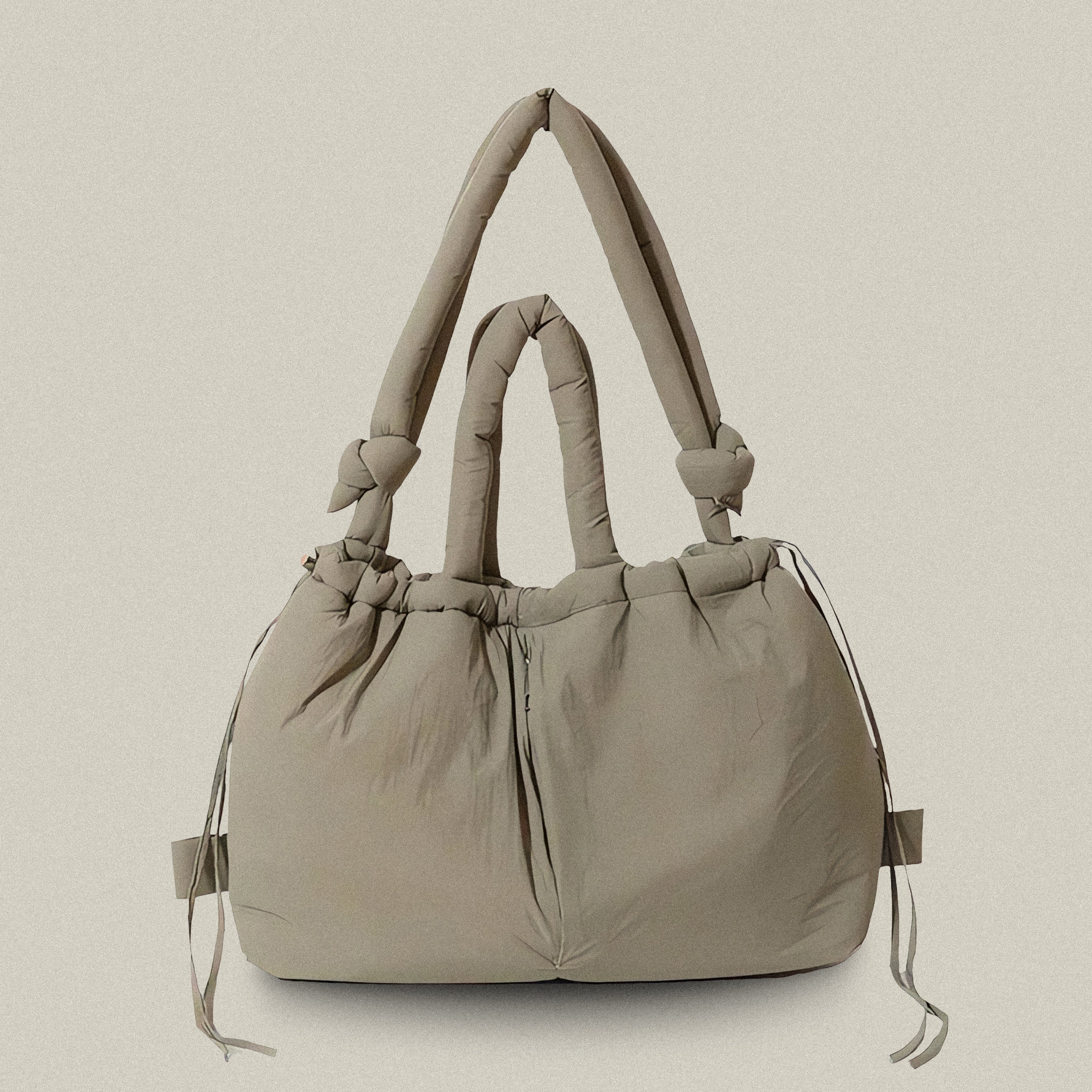 PLSH taupe women’s designer puffer handbag on a white background