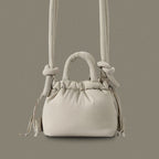 PLSH light gray women’s designer puffer handbag on a gray background