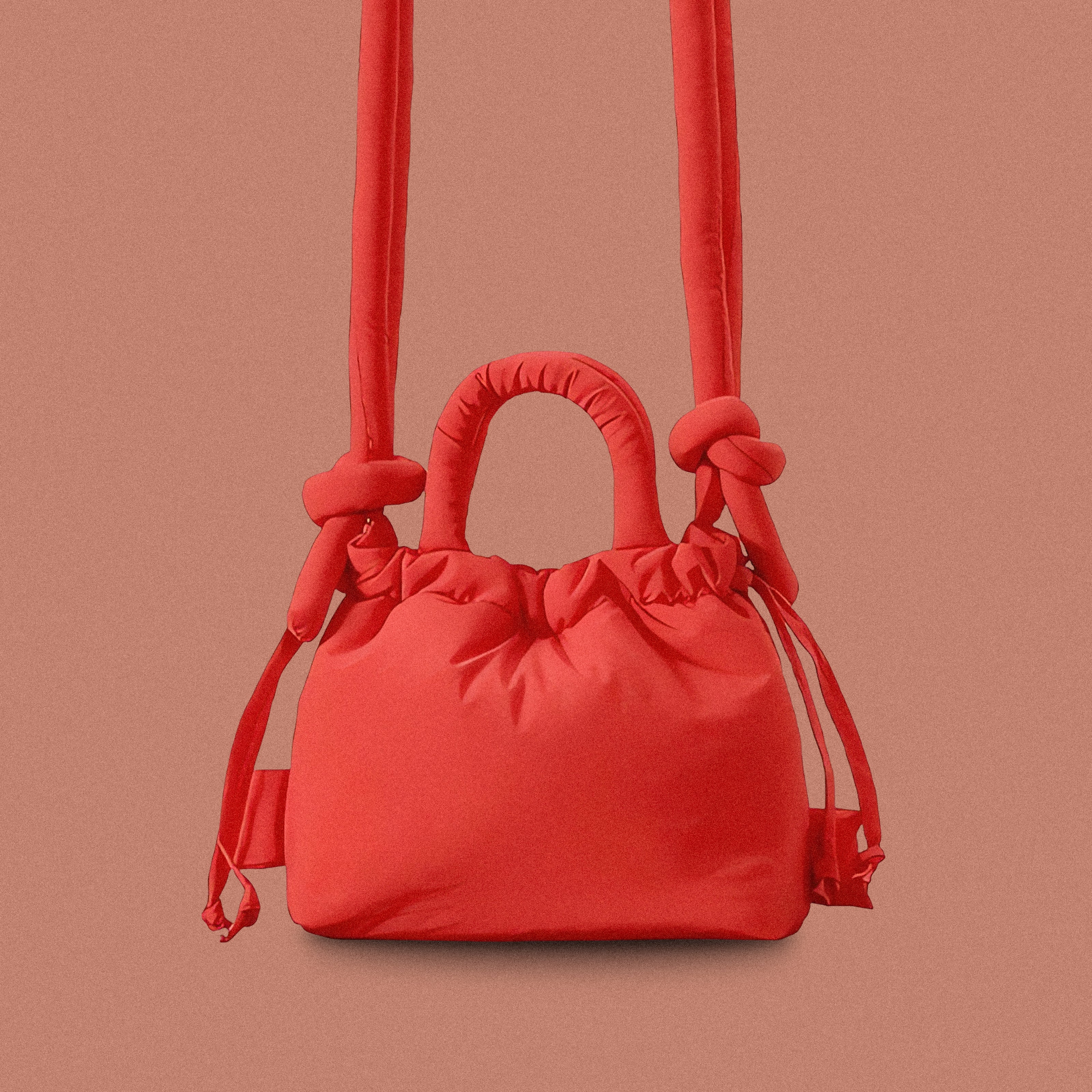 PLSH red women’s designer puffer handbag on a red background