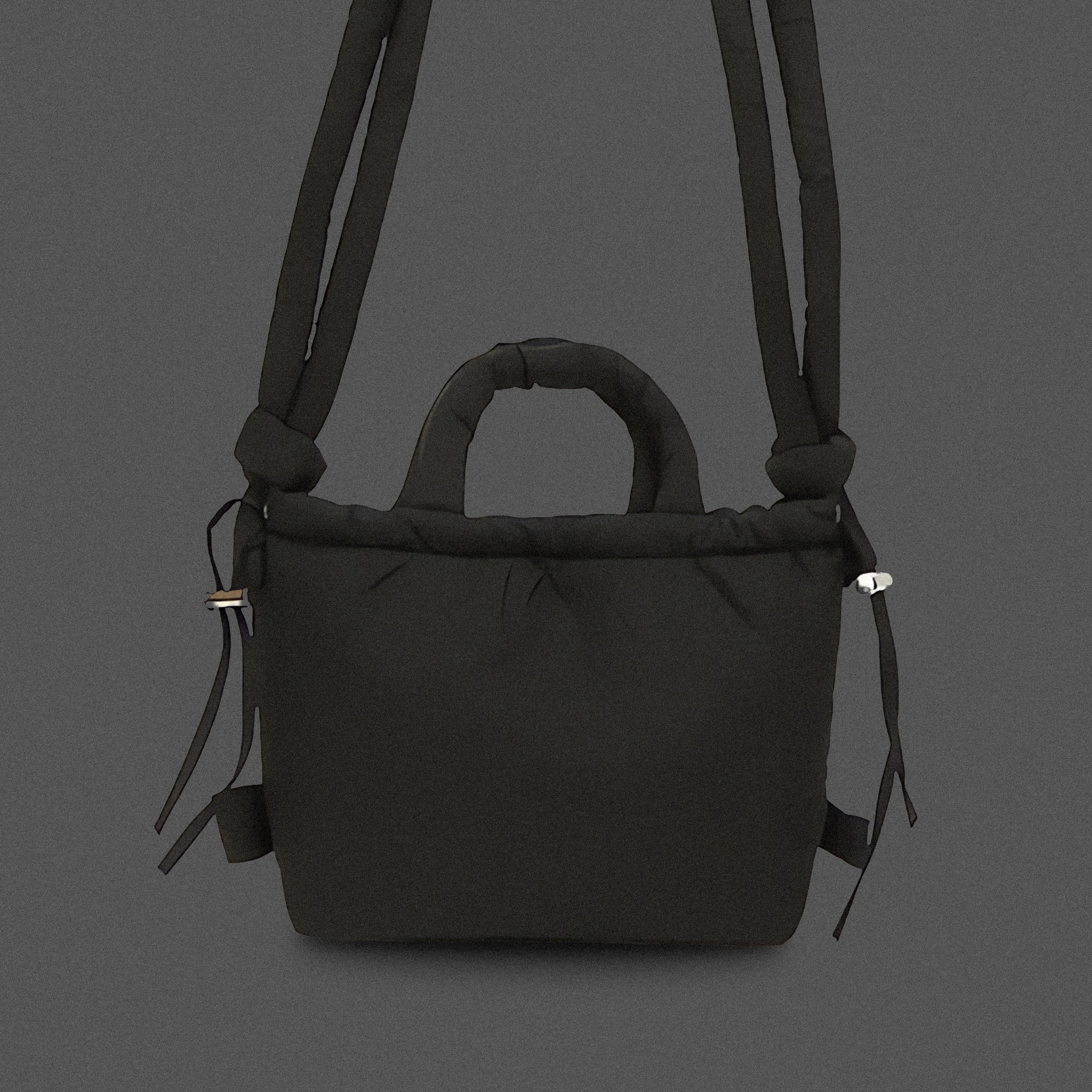 PLSH black women’s designer puffer handbag on a black background