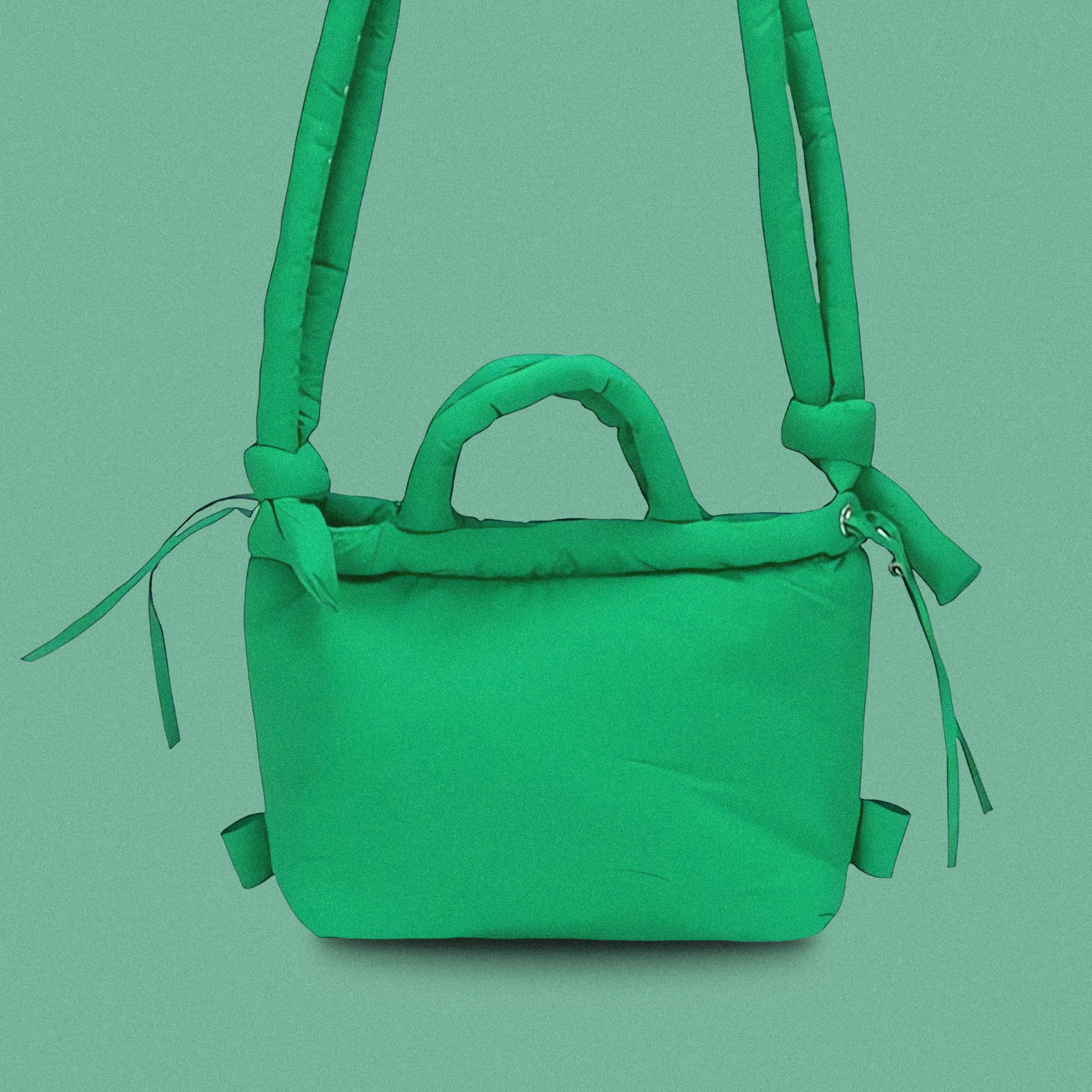 PLSH green women’s designer puffer handbag on a green background