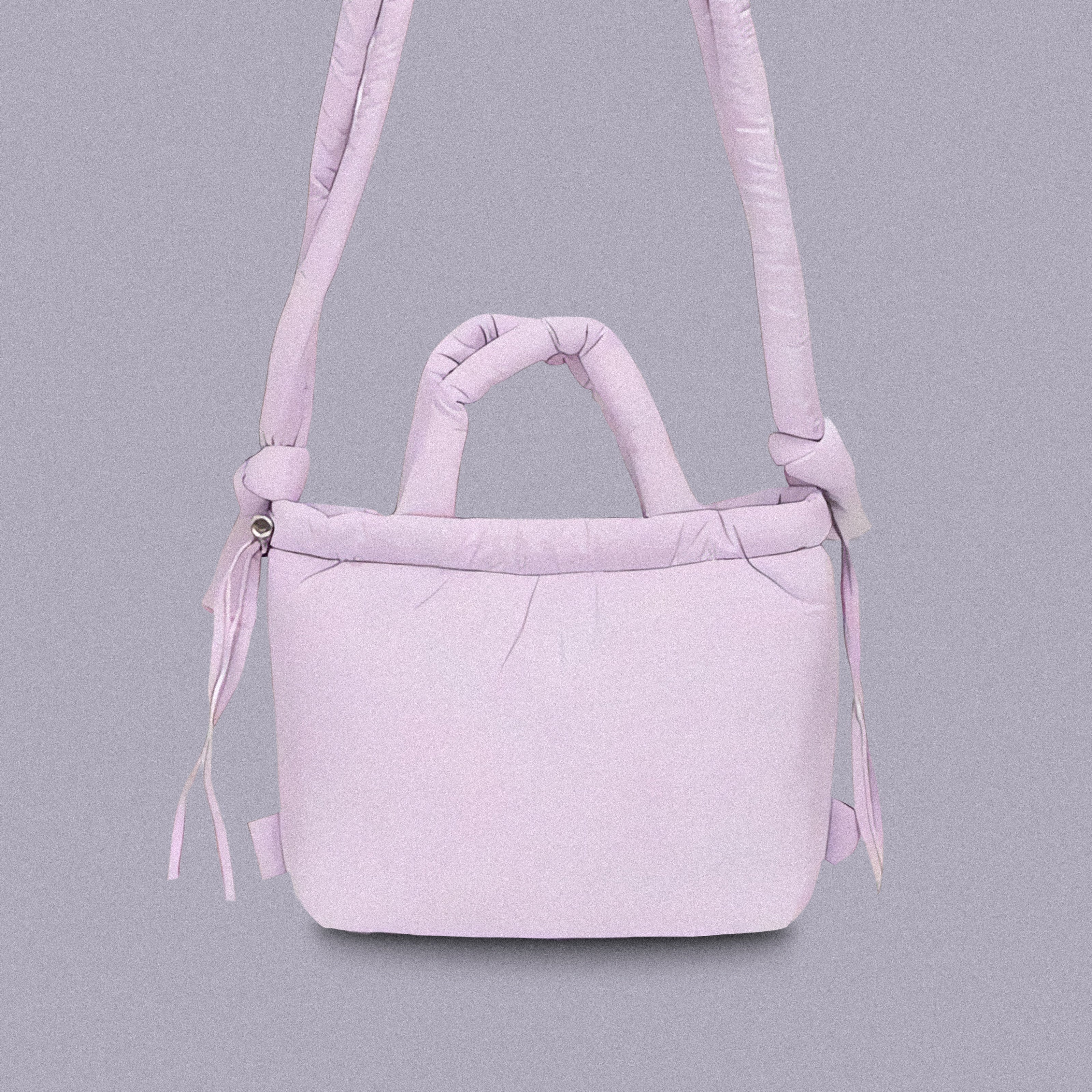 PLSH lilac women’s designer puffer handbag on a lilac background