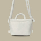 PLSH white women’s designer puffer handbag on a white background