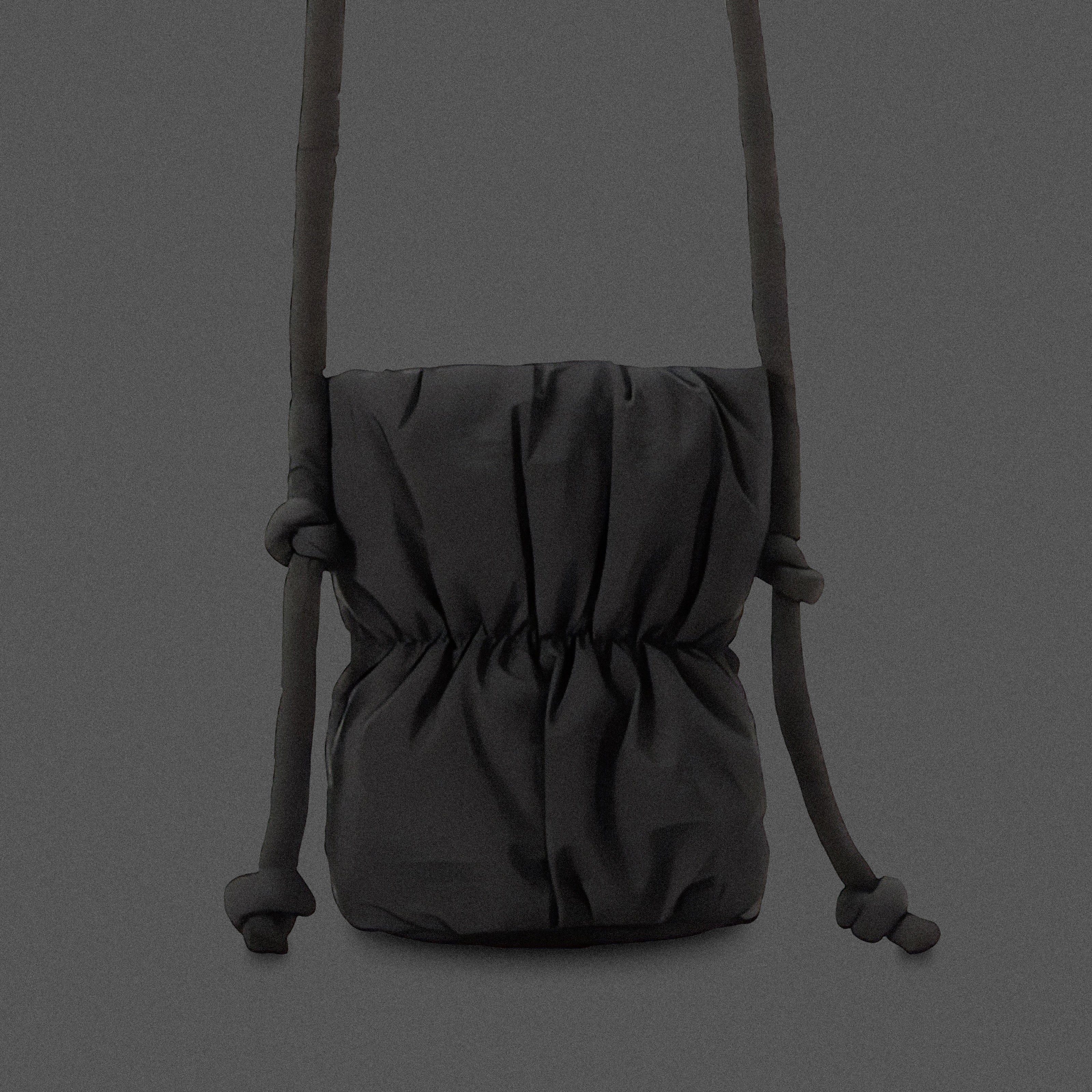 PLSH black women’s designer puffer handbag on a gray background