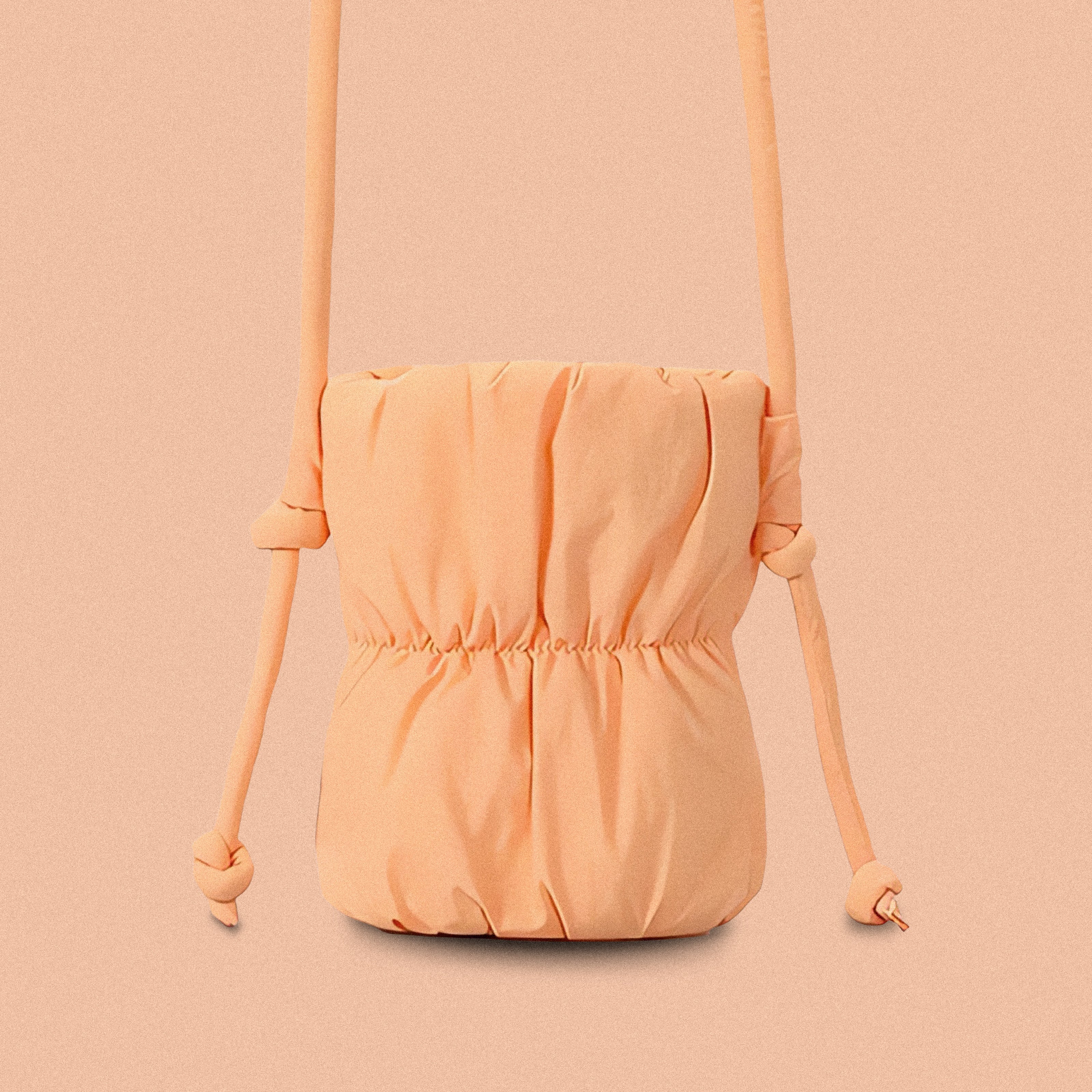 PLSH orange women’s designer puffer handbag on a orange background