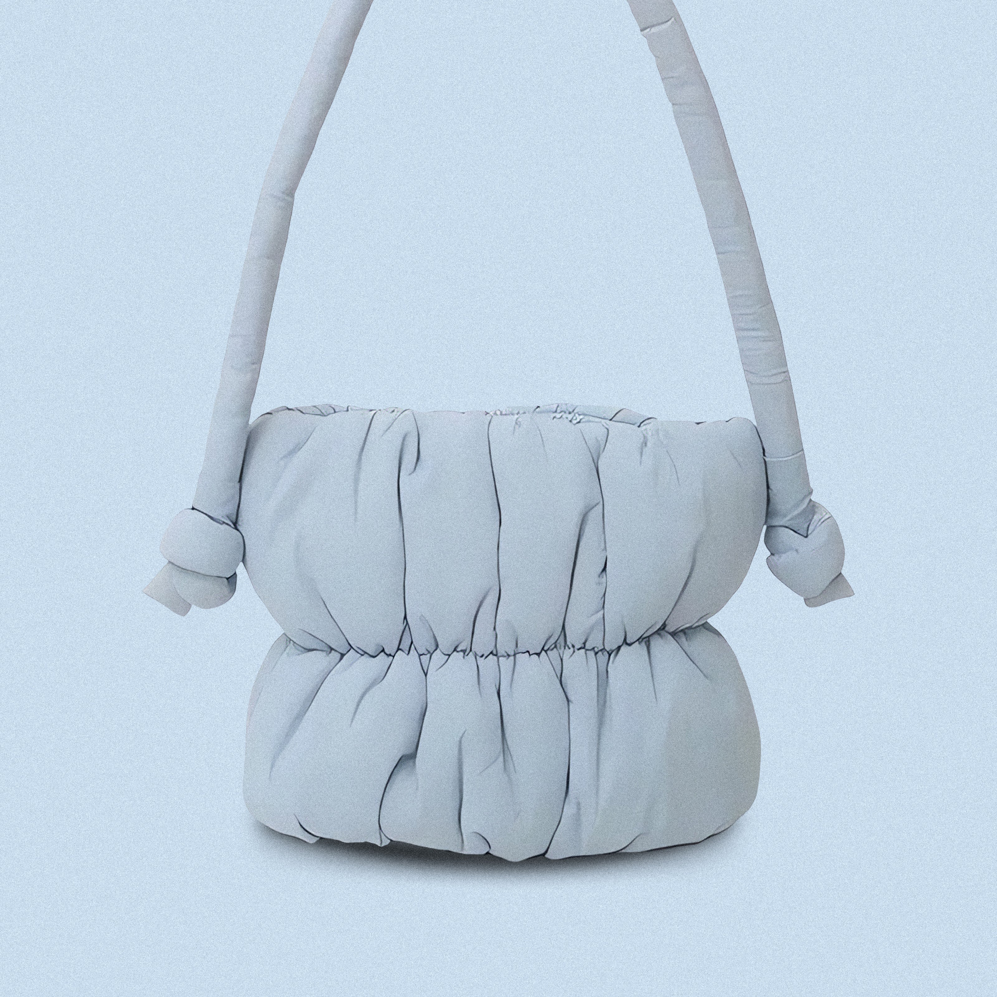 PLSH baby blue women’s designer puffer handbag on a blue background