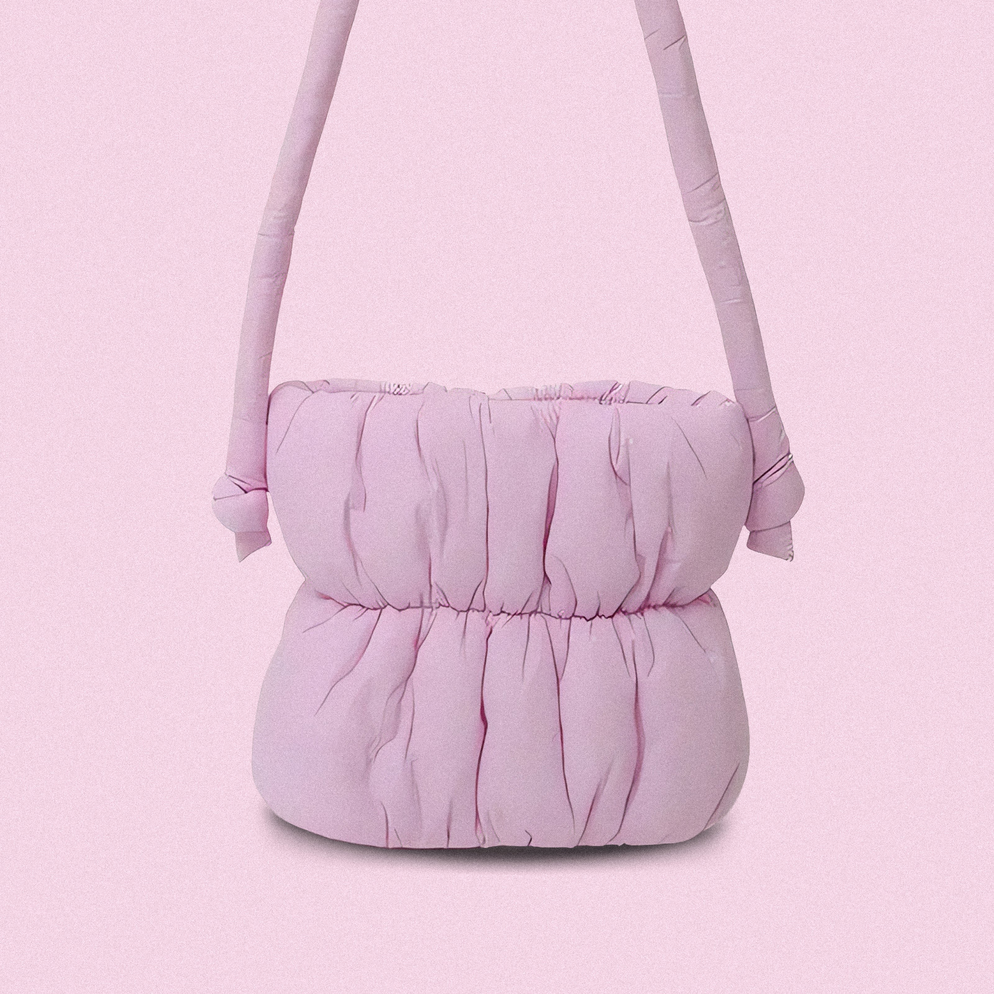 PLSH pink women’s designer puffer handbag on a pink background