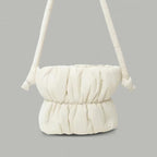 PLSH white women’s designer puffer handbag on a gray background