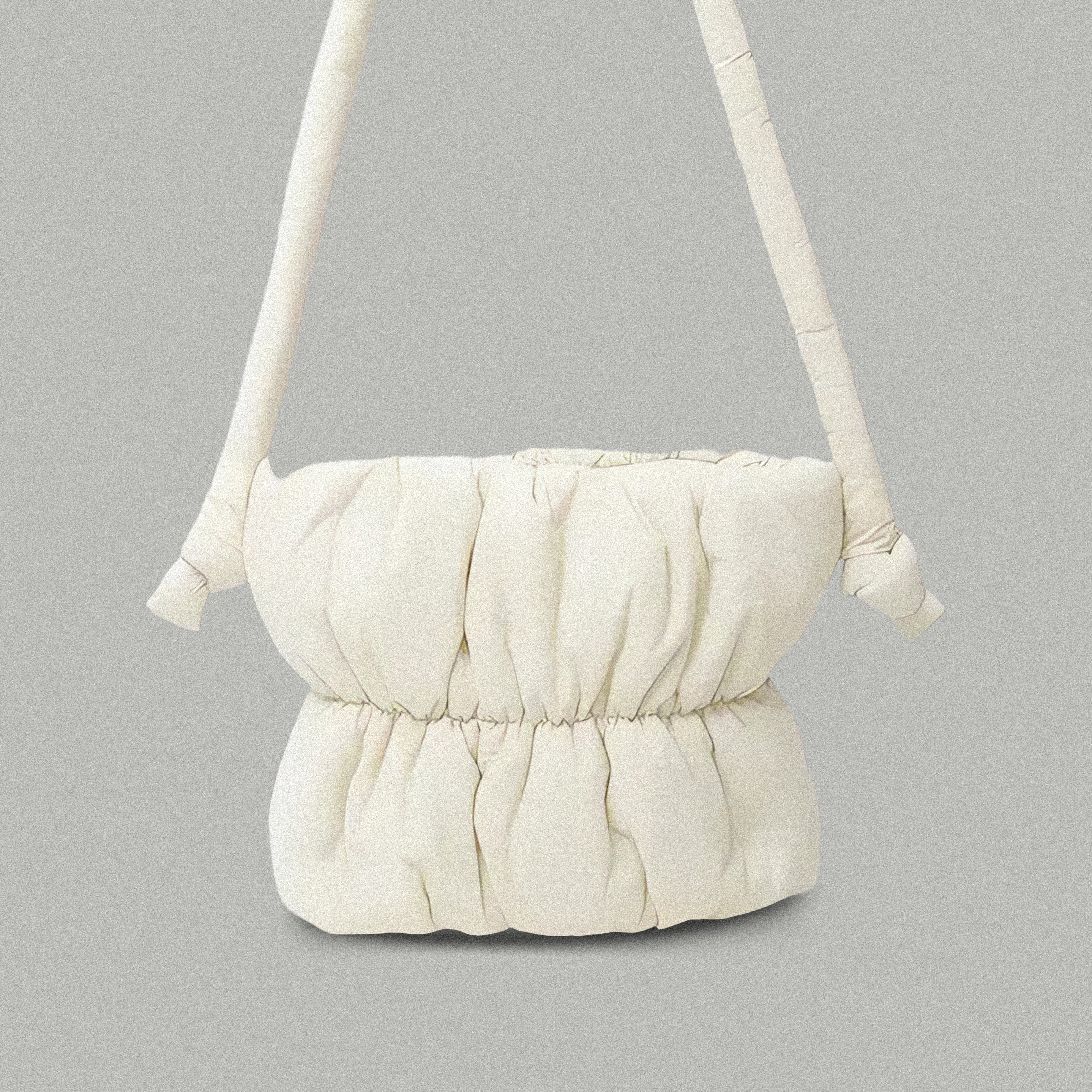 PLSH white women’s designer puffer handbag on a gray background