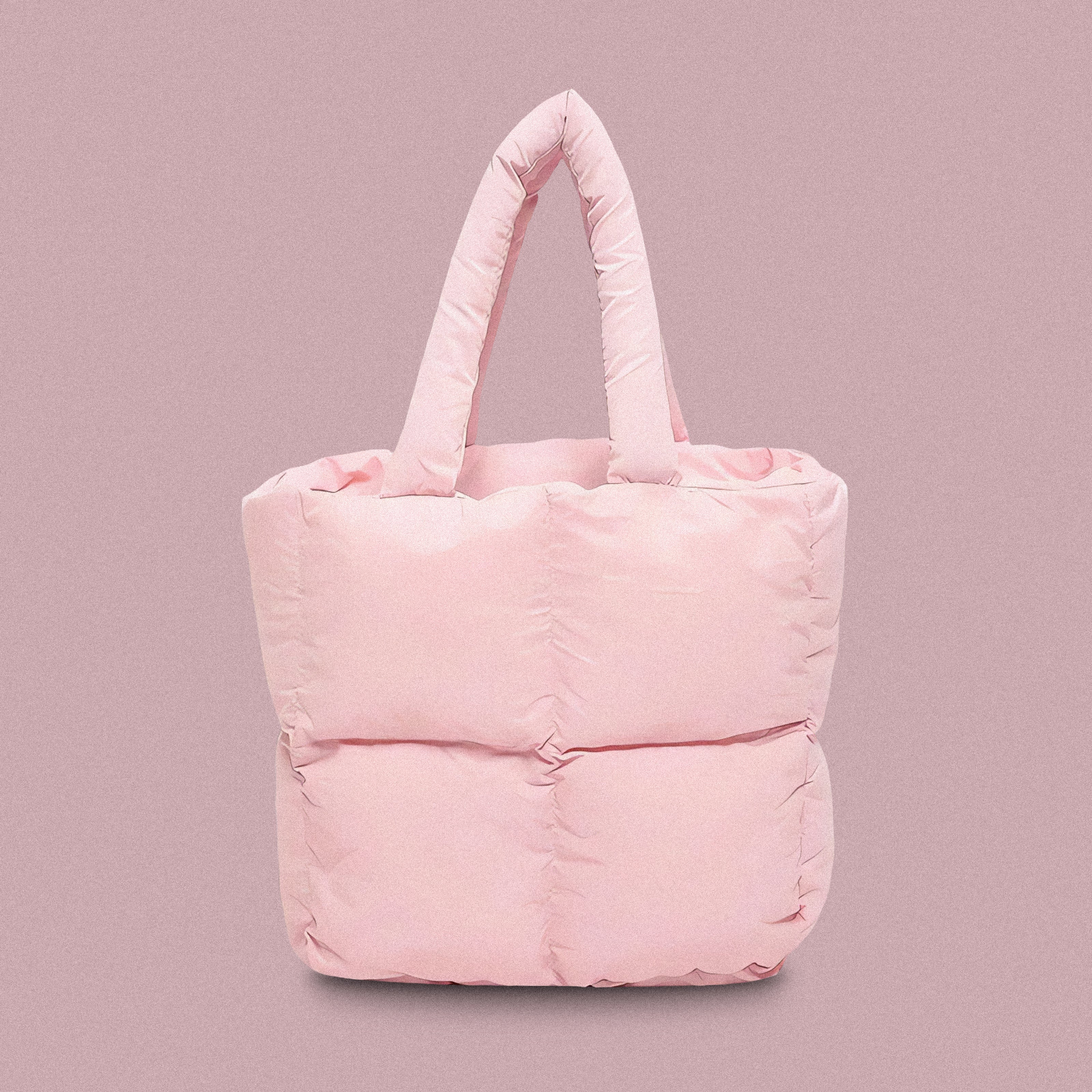 PLSH baby pink women’s designer puffer handbag on a pink background