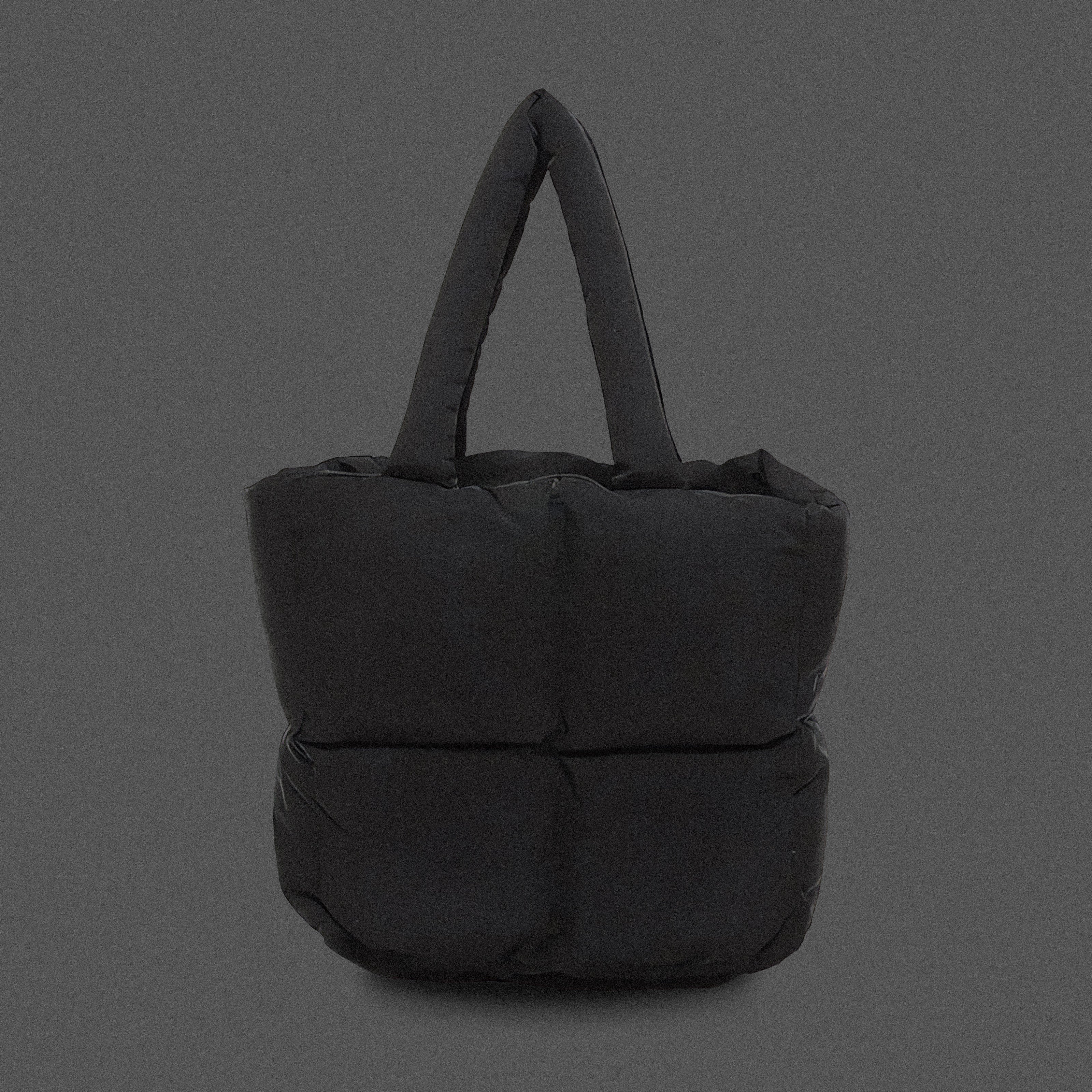 PLSH black women's designer puffer handbag on a gray background