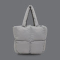 PLSH light gray women’s designer puffer handbag on a gray background