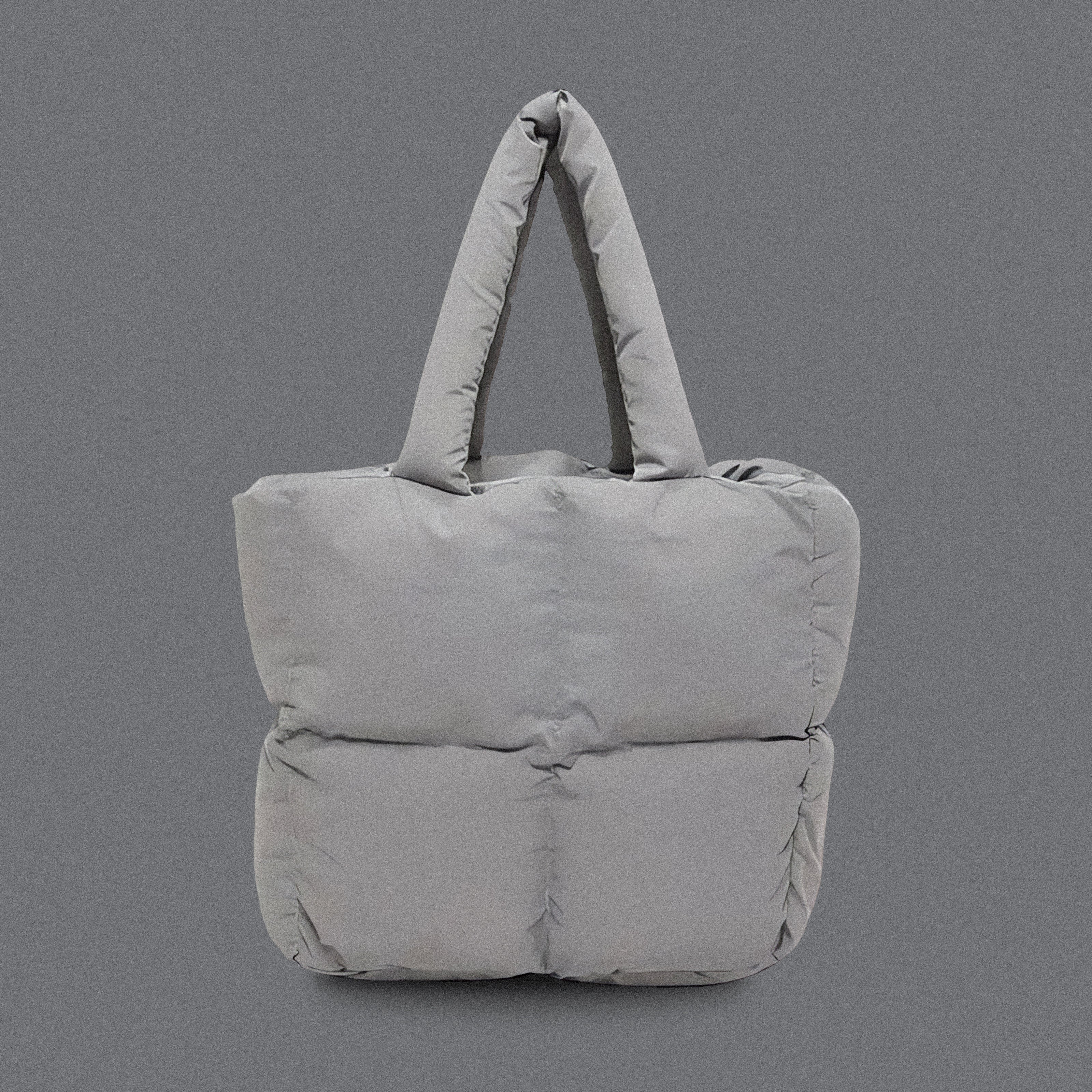 PLSH light gray women’s designer puffer handbag on a gray background