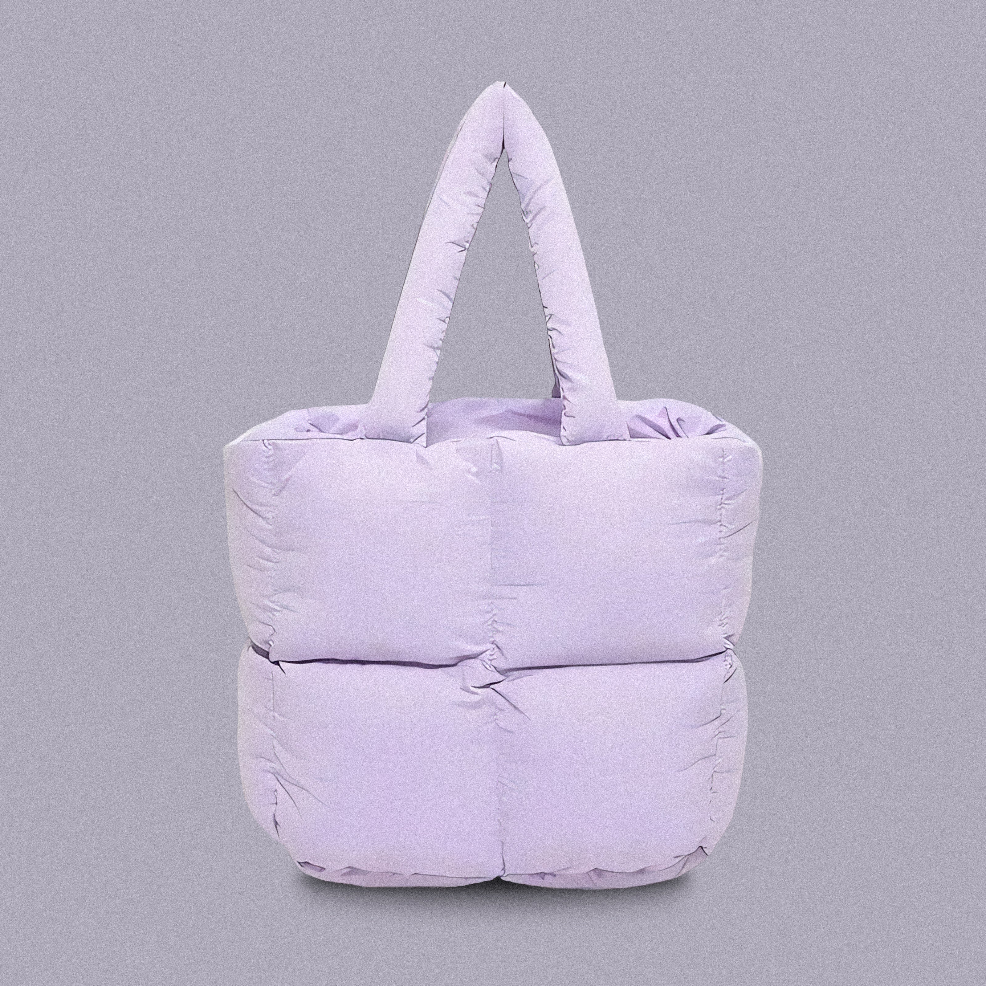 PLSH lilac women’s designer puffer handbag on a lilac background
