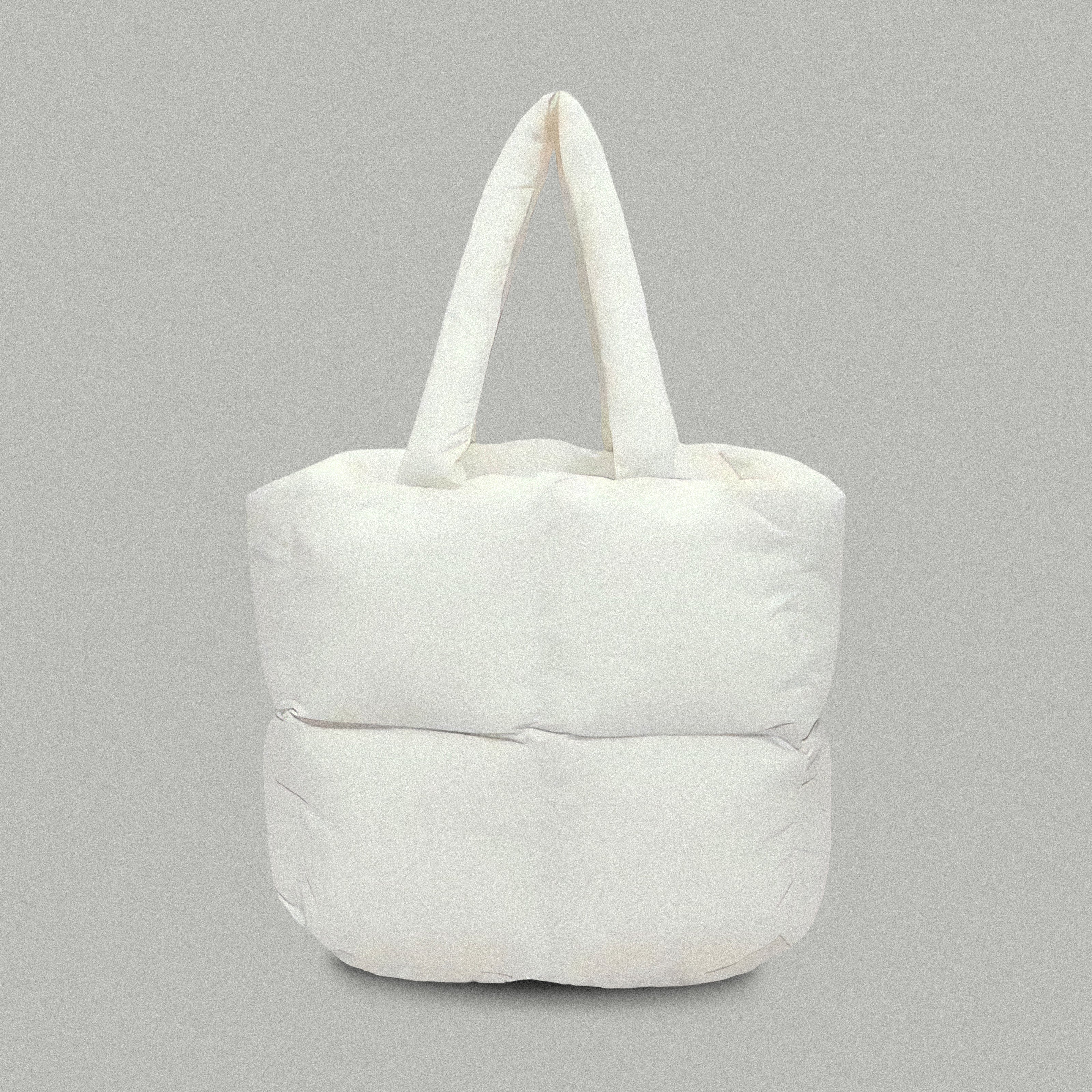 PLSH white women’s designer puffer handbag on a gray background