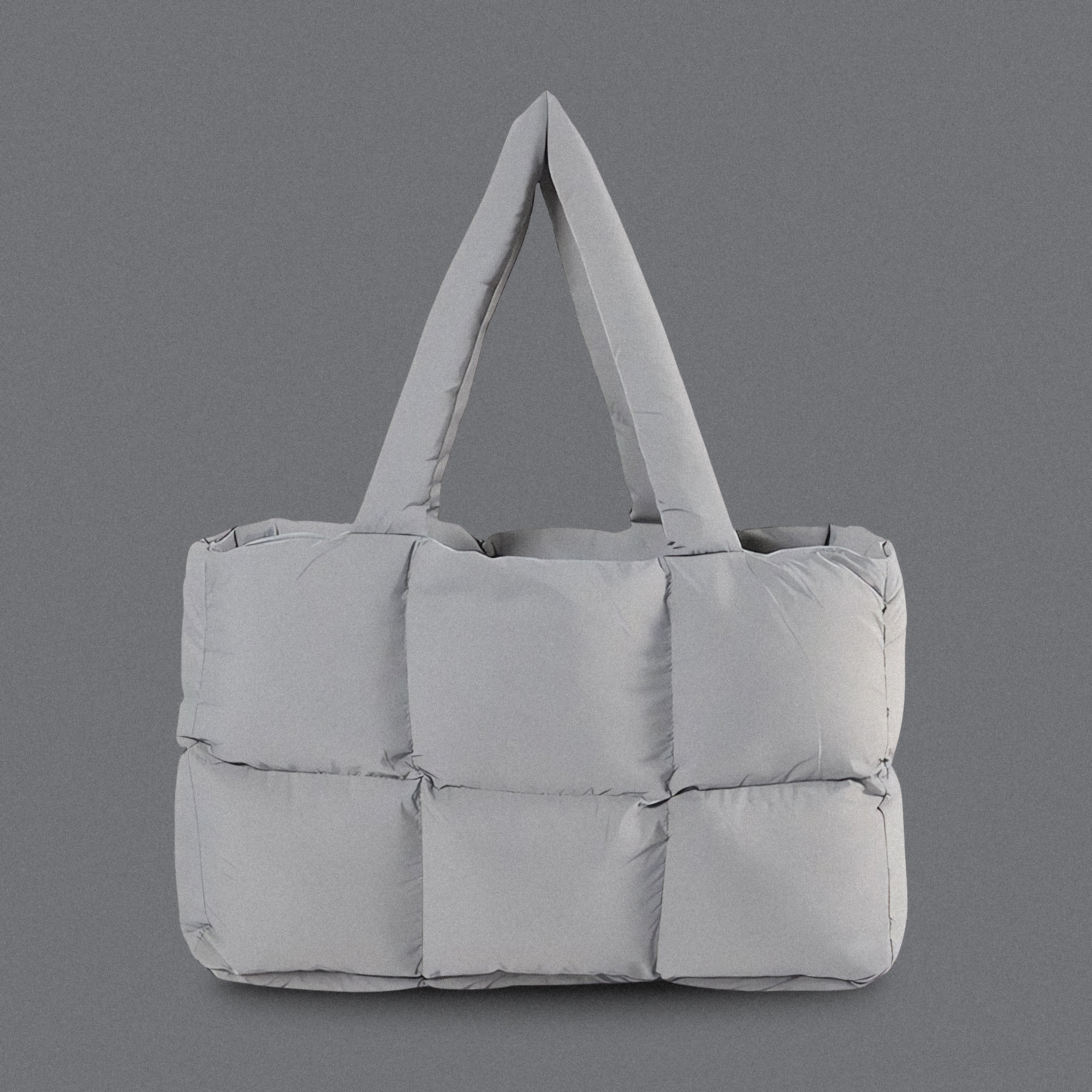 PLSH light gray women's designer puffer handbag on a gray background