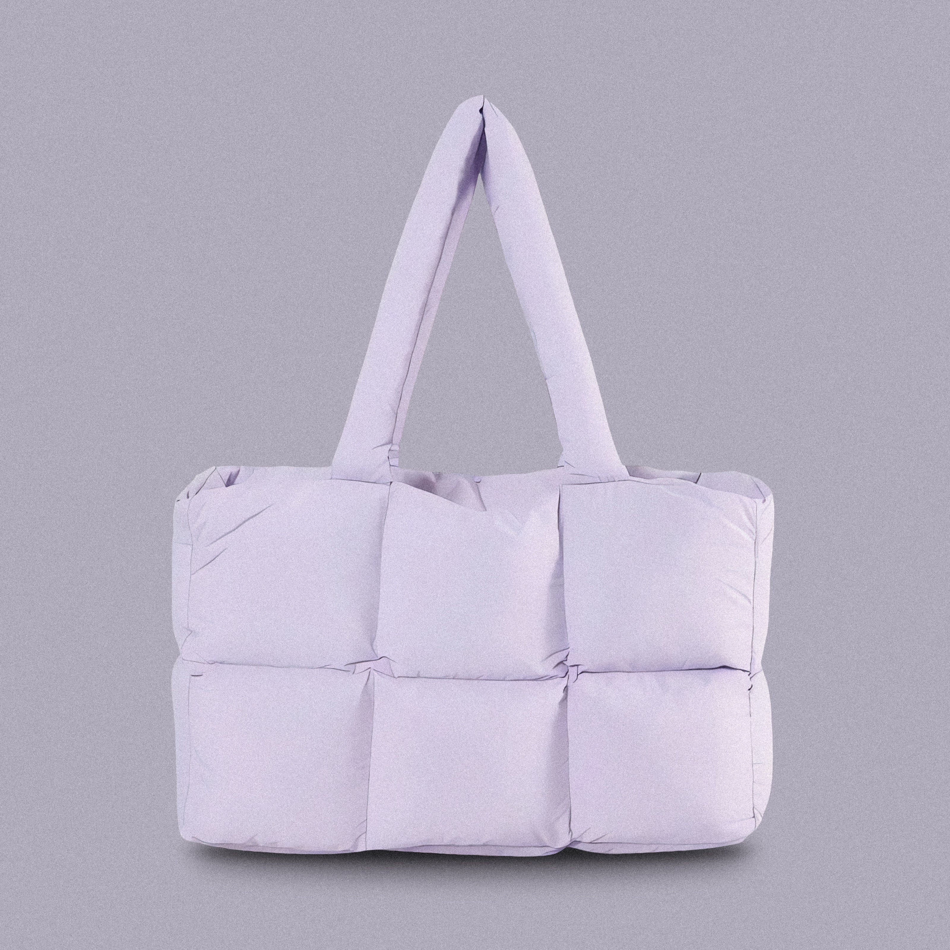PLSH lilac women's designer puffer handbag on a lilac background