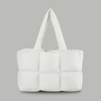 PLSH white women's designer puffer handbag on a gray background