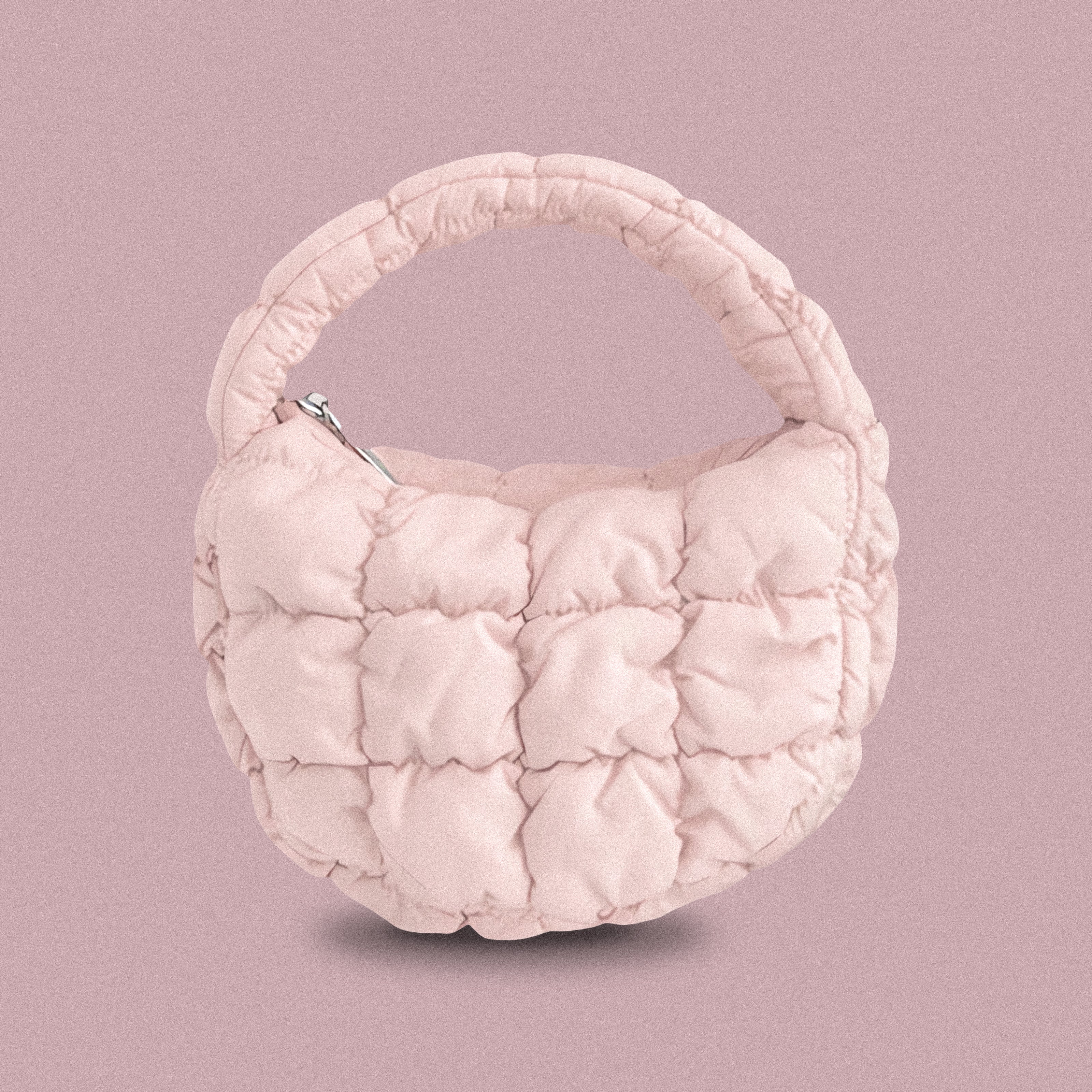 PLSH baby pink women’s designer puffer handbag on a pink background