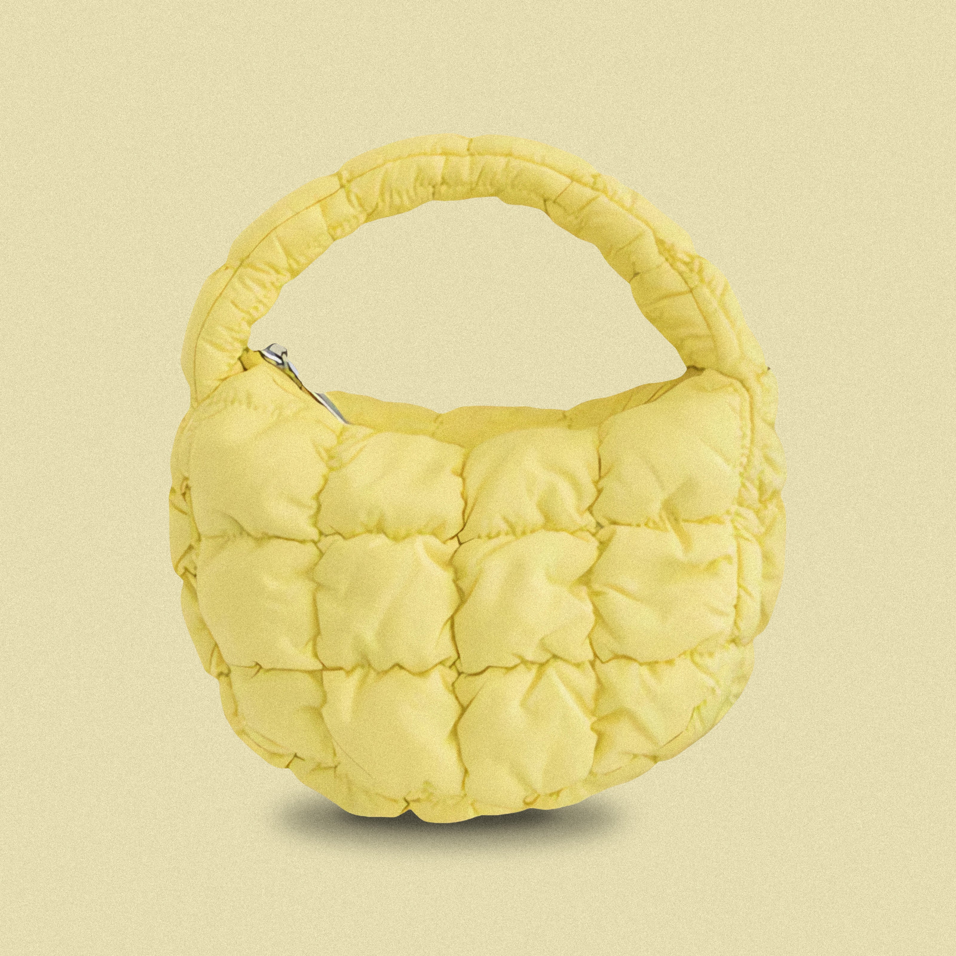 PLSH yellow women’s designer puffer handbag on a yellow background