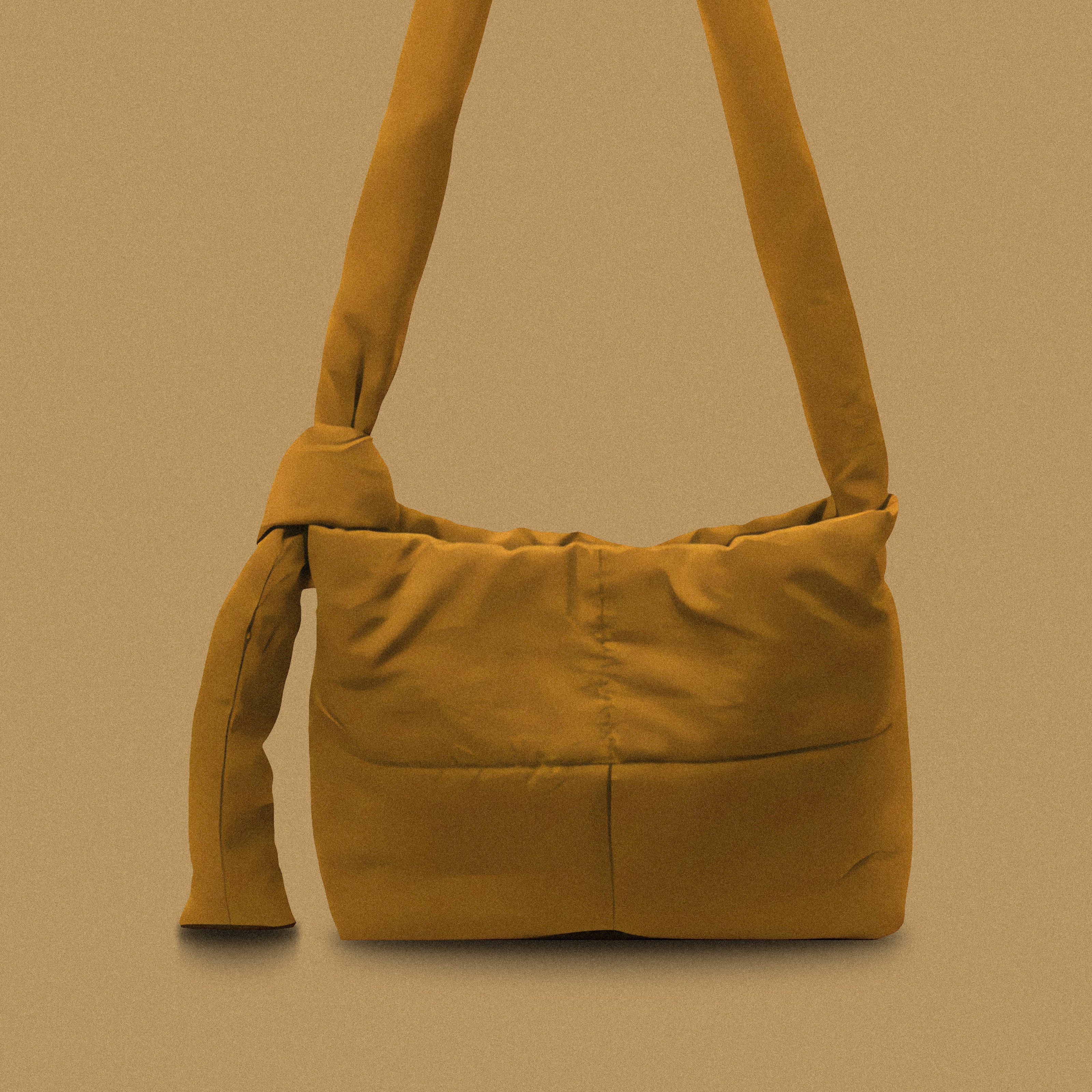 PLSH burnt yellow women’s designer puffer handbag on a yellow background