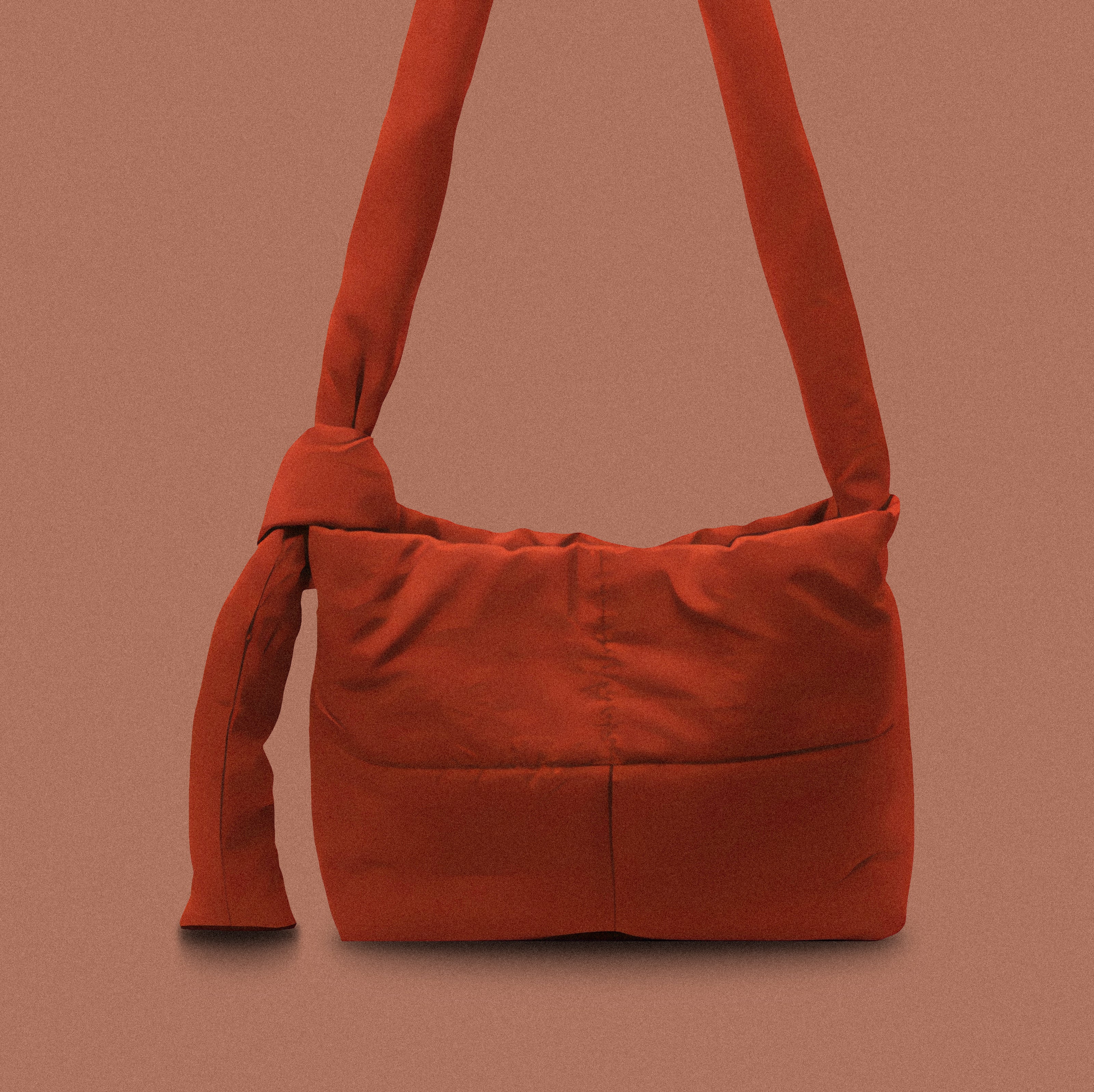 PLSH red women’s designer puffer handbag on a red background