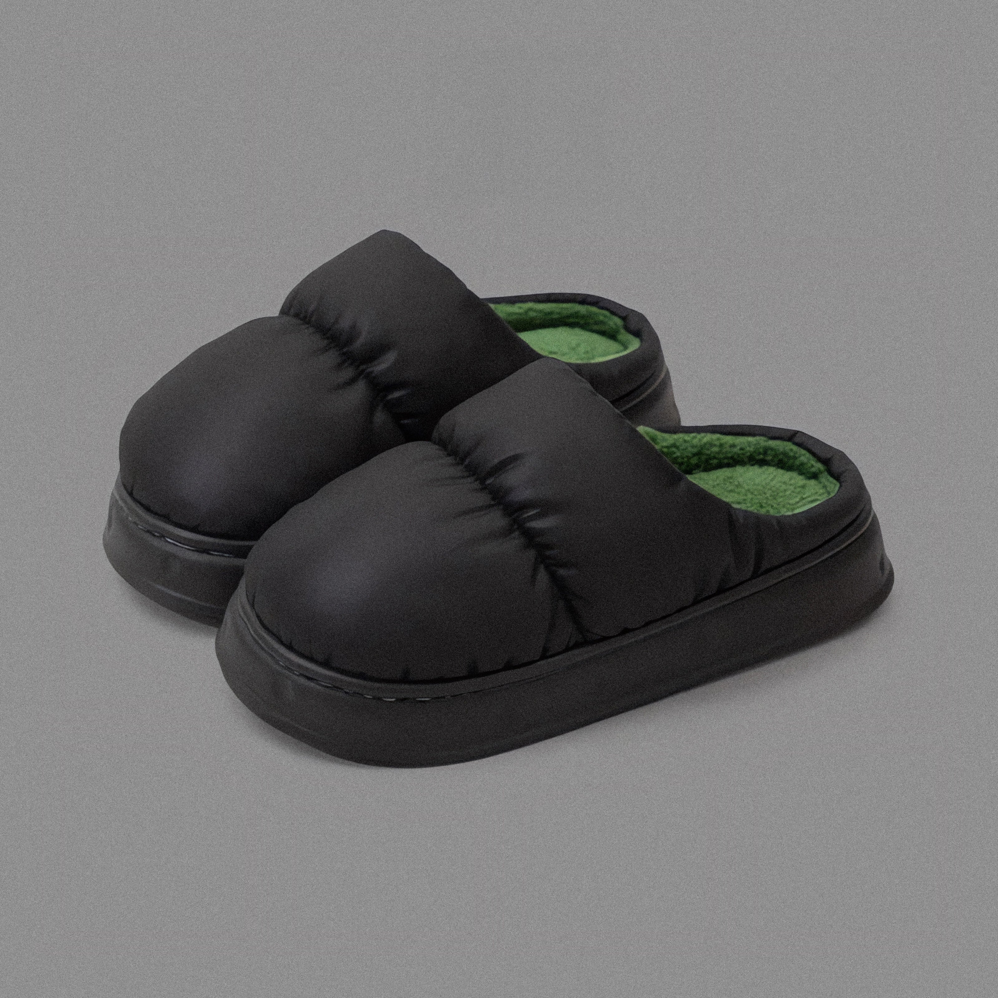 PLSH black women’s premium puffer slippers on a grey background