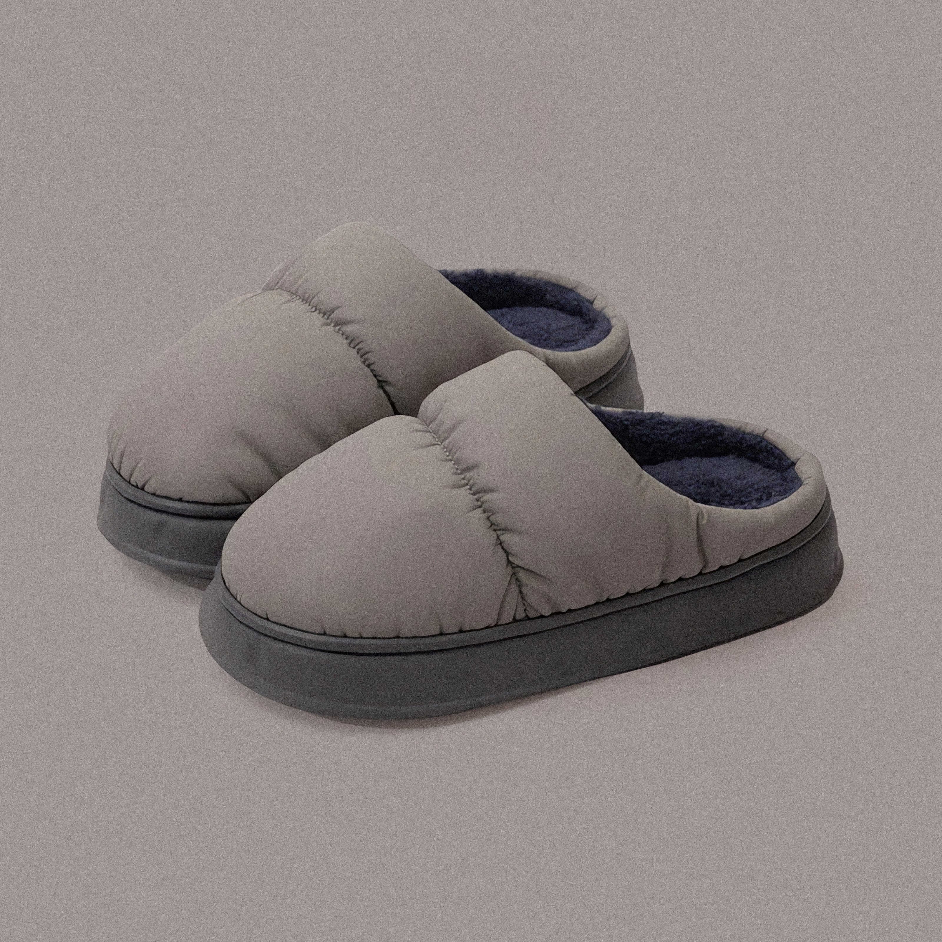 PLSH gray women’s premium puffer slippers on a gray background
