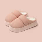 PLSH pink women’s premium puffer slippers on a pink background